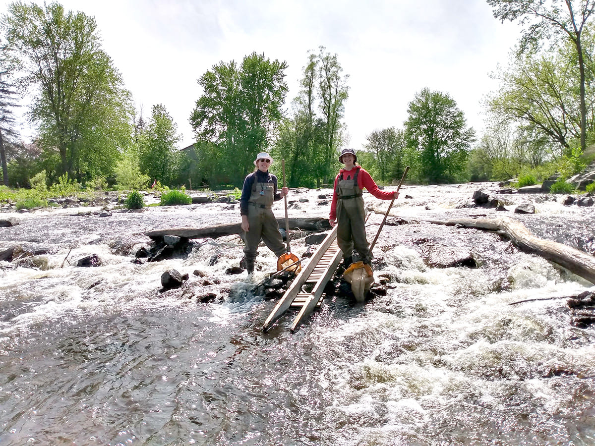 two people standing in shallow water