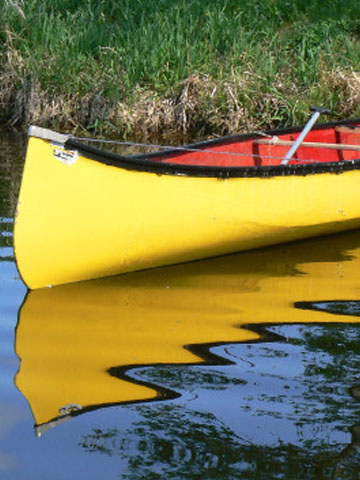 canoe pulled up onto the shore 